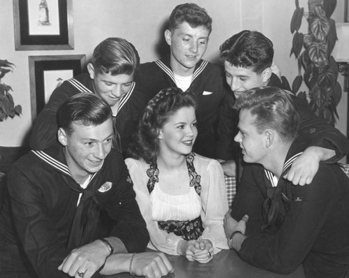 Actress Shirley Temple and a few Navy men