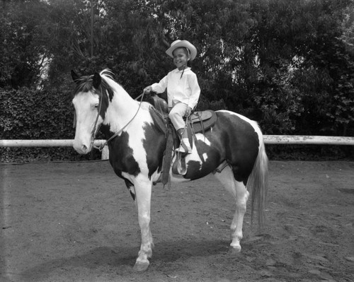 Unidentified young girls ride horseback