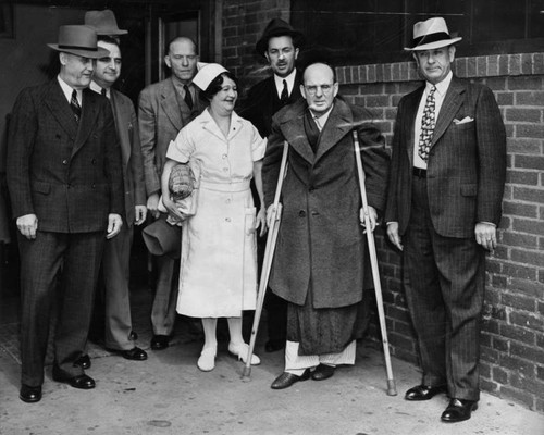 Harry Raymond with crutches outside courthouse