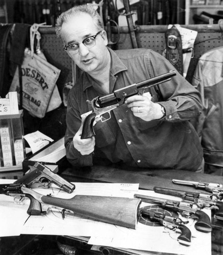 Dealer Joe Bickston displays revolver