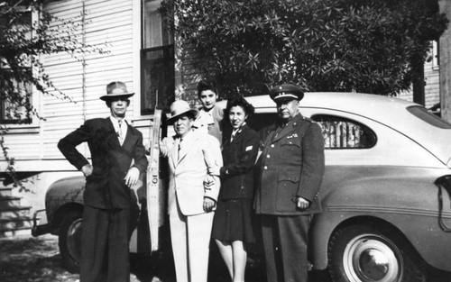 Mexican American family and friends with car