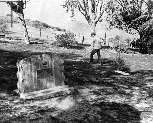 Worker cleans grave area at Calabasas pet cemetery