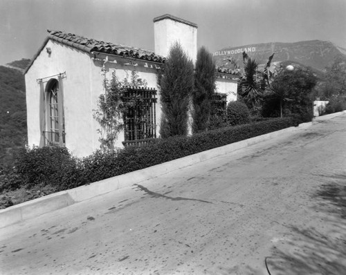 House on a hill below Hollywoodland sign