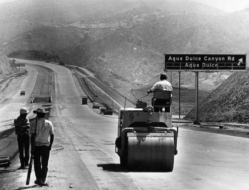 Workmen finish Antelope Valley freeway's first link in preparation for dedication today-16 miles connecting Los Angeles with the desert