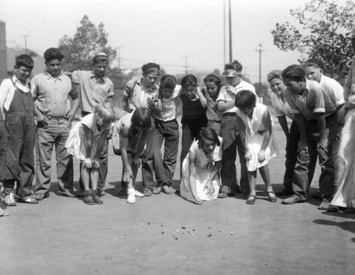 Children playing marbles, view 8