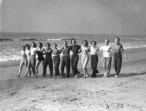 Young women walking on the beach