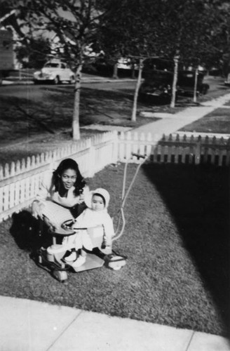 Mother and baby daughter in front yard