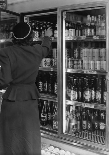 Woman reaching for a cold drink