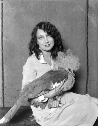 Woman holding long-crested fowl