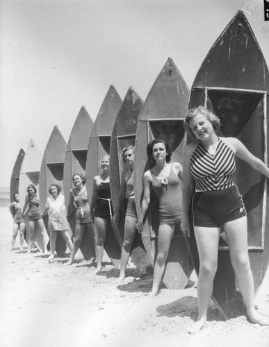 Beach beauties pose with kayaks, view 2