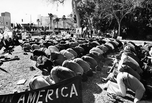 Muslim demonstrators performing salah