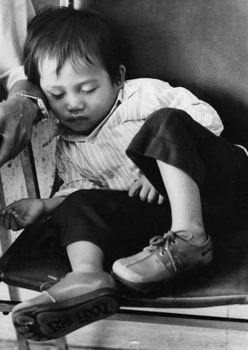 Vietnamese child waits to be processed