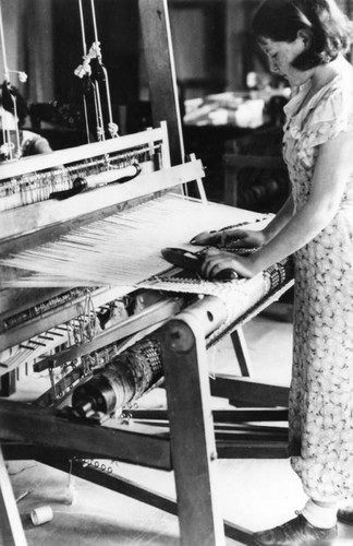 American Indian student working on loom
