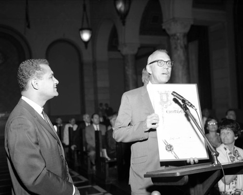 Billy Mills and Art Snyder present resolution to Dr. Everett B. Chaffee