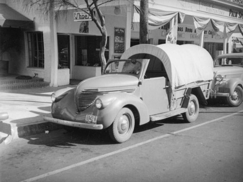 Covered wagon in front of the Palms Springs Drug and Import Company