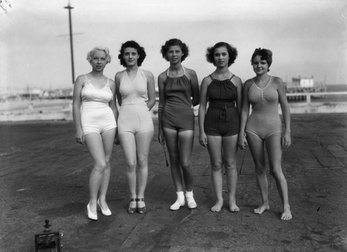 Five women in swimsuits on Venice boardwalk