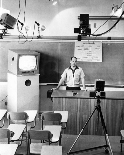 Valley State audio-visual technician checks TV setup