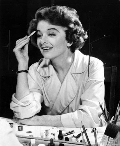 Myrna Loy applying makeup