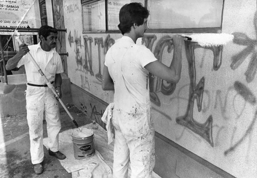 City workers paint out graffiti