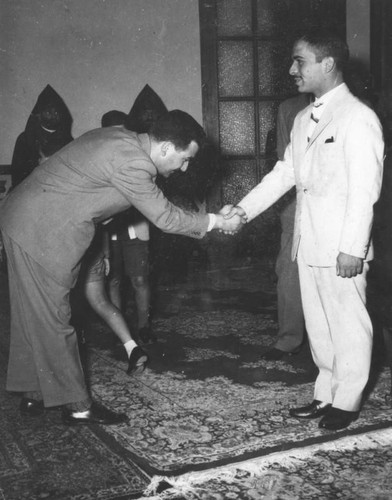 King Hussein shakes hands