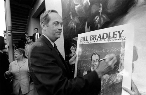 Bill Bradley signs his poster