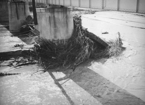 L.A. River flooding, debris around railroad bridge in North Hollywood