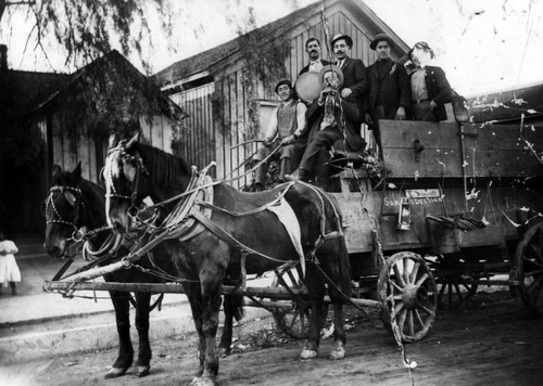 Group of men in a horse-drawn cart