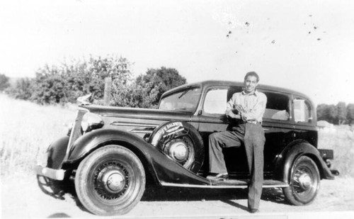 Man posing with car