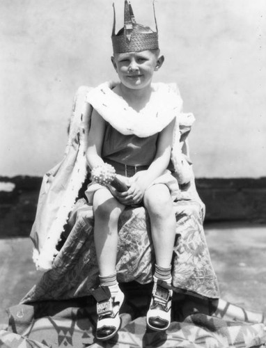 Young boy wearing crown