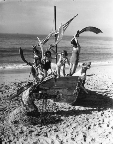 Beach beauties pose with sea dragon, view 2