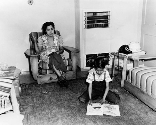 Mother and son in their apartment, Ramona Gardens