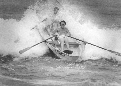 Into the surf in small, wooden boats