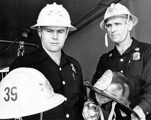 Fireman Bullard, left, Capt. Tolman don new hats