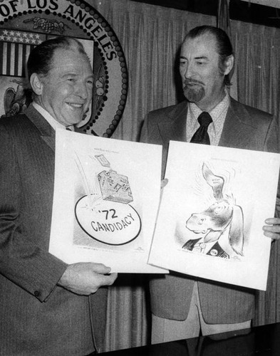 Mayor Yorty chuckles at cartoons