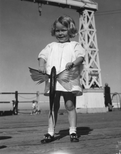 Girl holds flying fish