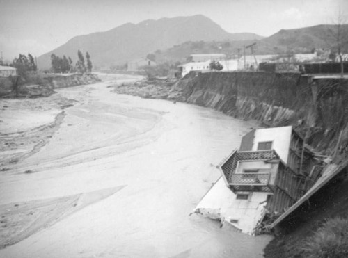 L.A. River flooding, house and winding river in North Hollywood