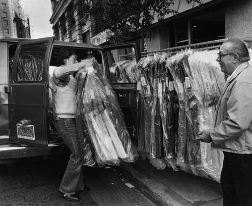 Unloading a rack of clothes