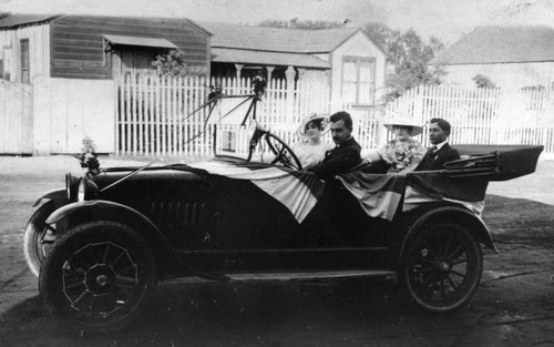 Group in car decorated for 4th of July parade