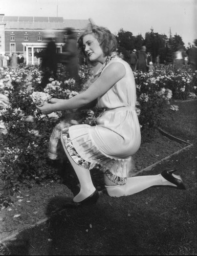 Young woman in rose garden