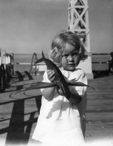 Girl holds flying fish