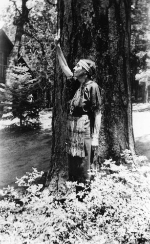 American Indian woman with raised hand