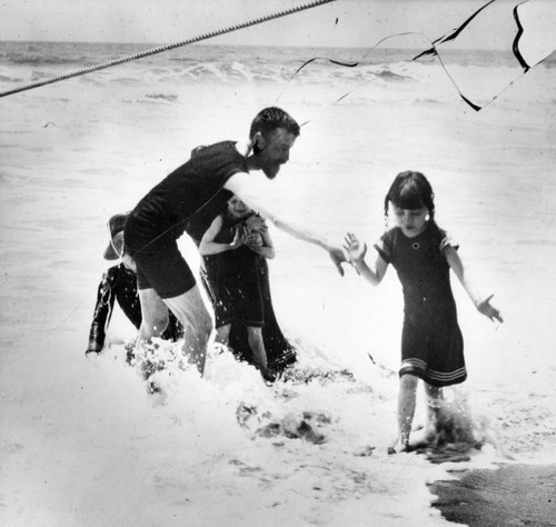 Father and his family in the surf