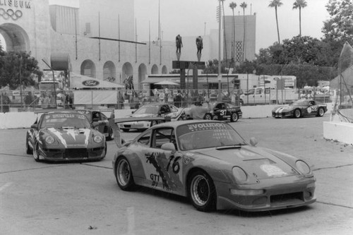 Race cars in front of the Coliseum