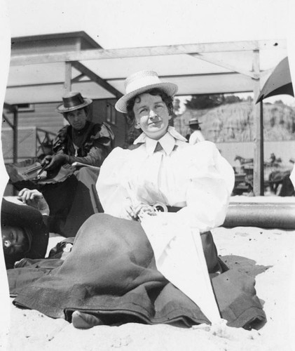 Young woman sitting on the sand