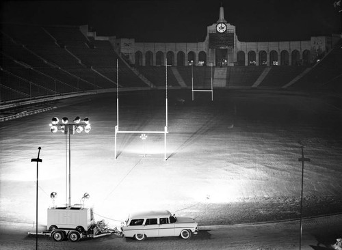 Coliseum at night with a mobile light