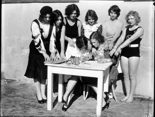 Women bleaching their fingernails