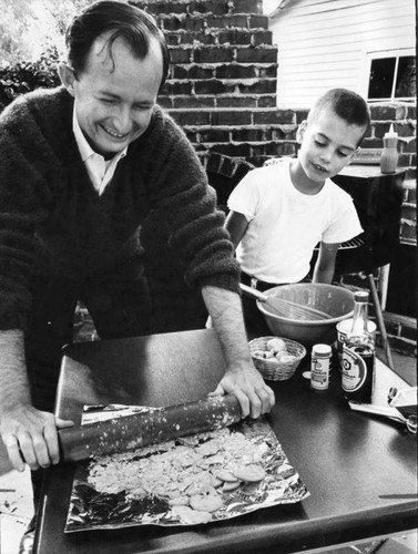 Tom rolls crackers into crumbs for meatloaf mixture