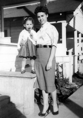 Mother and girl outside home