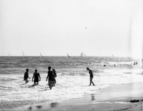 Swimmers on the beach and boaters in the ocean