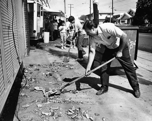 Shoveling up bricks after the quake